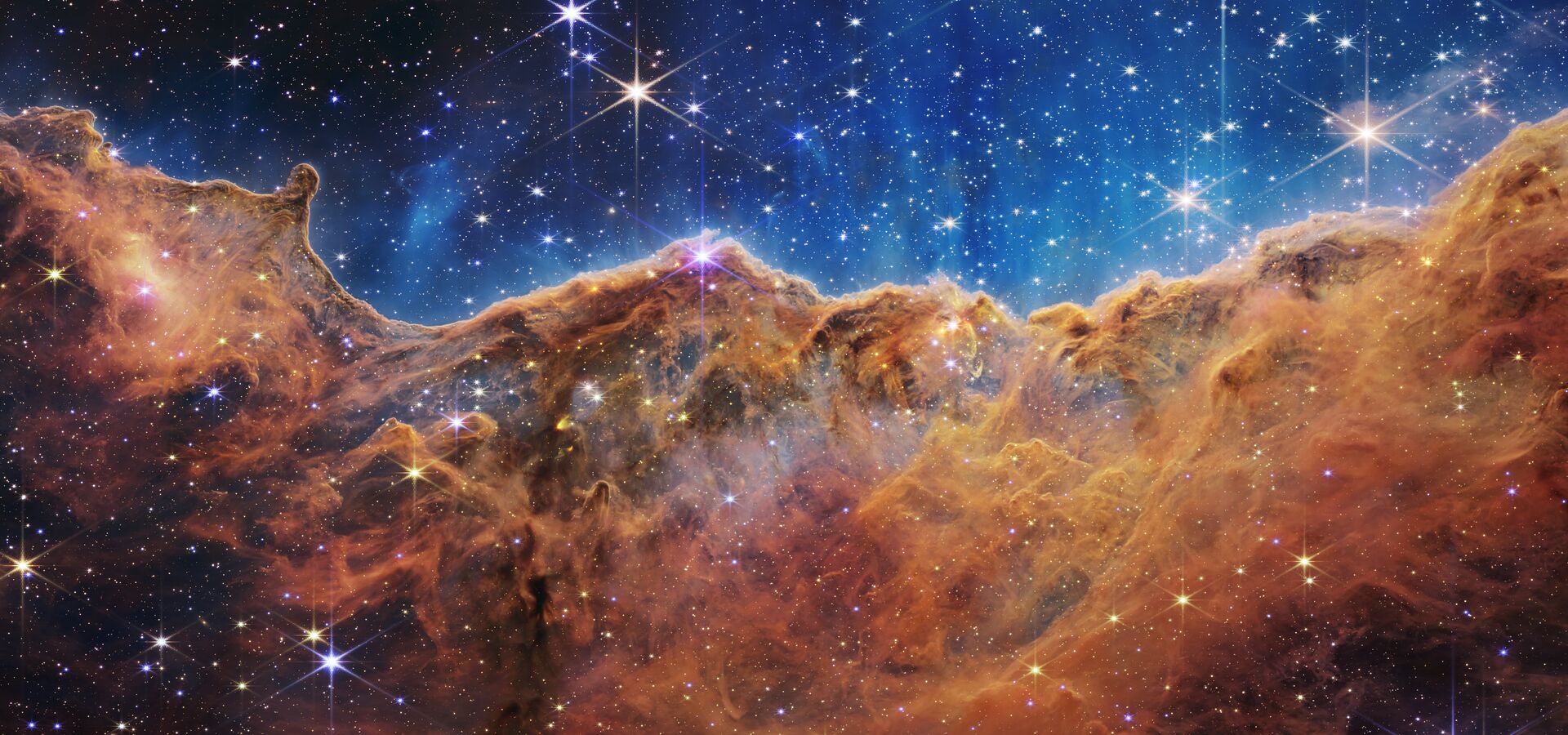 Webb Reveals Cosmic Cliffs, Glittering Landscape of Star Birth