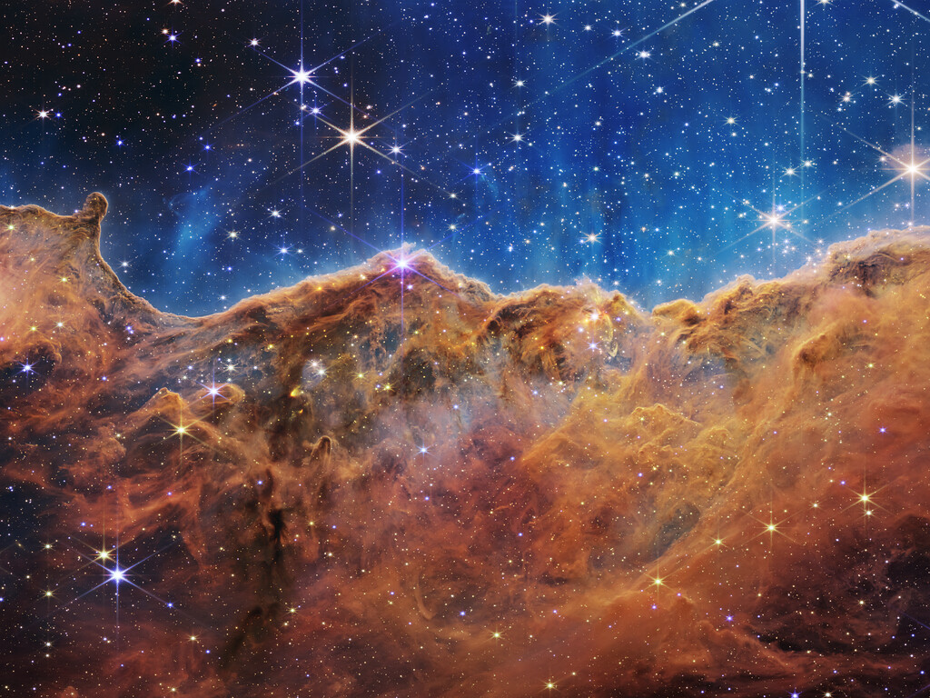 Webb Reveals Cosmic Cliffs, Glittering Landscape of Star Birth